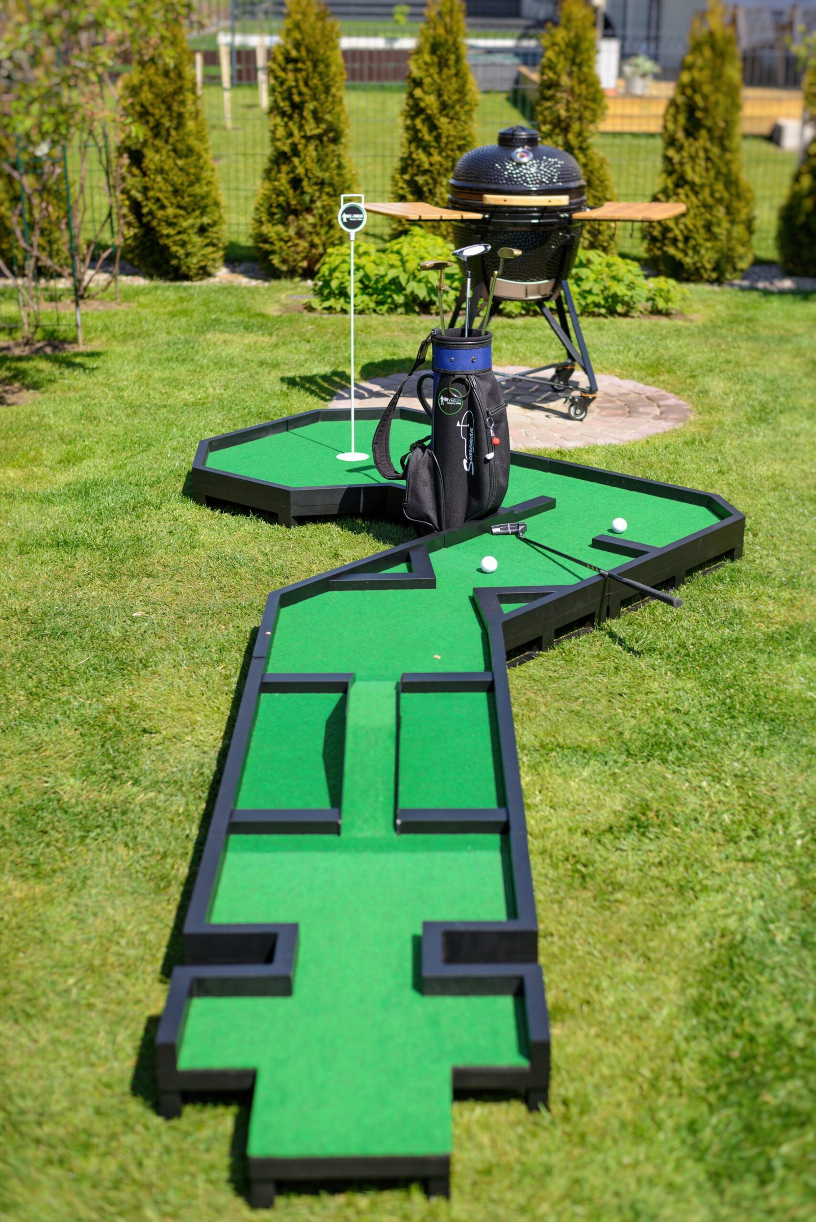 Portable modular mini golf course installed in a backyard